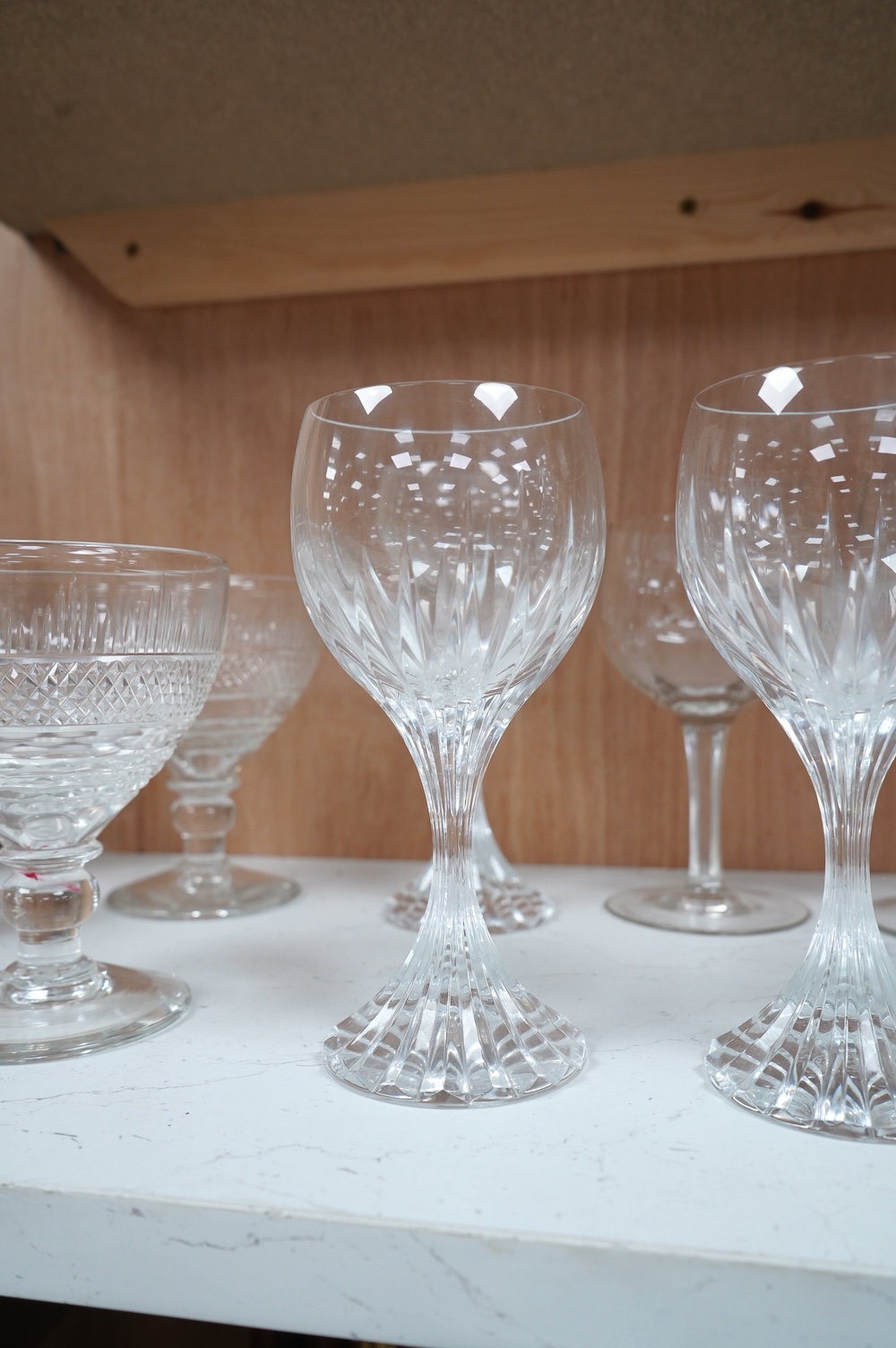 Three Baccarat (stamped) crystal ‘Massena’ cut glass wine goblets, a pair of late 19th century cut glass rummers and a set of six 20th century faceted wine glasses, Baccarat glasses 17.5cm high. Condition - good